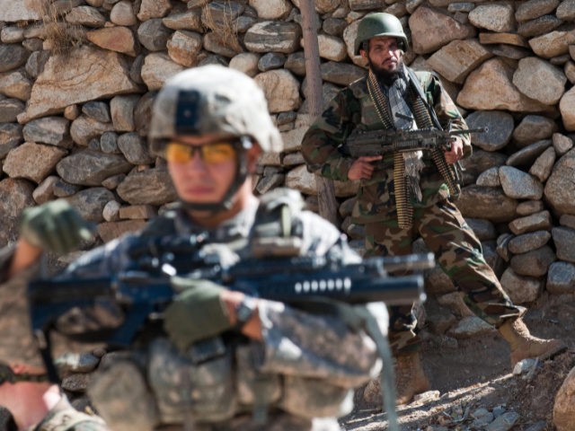 US Army Specialist Patino of the 2-12 Infantry, 4th Brigade, 4th Infantry Division, takes up position as an Afghan soldier stands guard during a combined US and Afghan National Army patrol as they search mountains for insurgents during a route clearing mission in the Pich Valley of Kunar Province, eastern …