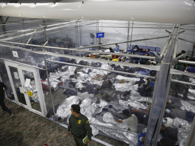 In this March 30, 2021, file photo, young minors lie inside a pod at the Donna Department of Homeland Security holding facility, the main detention center for unaccompanied children in the Rio Grande Valley run by U.S. Customs and Border Protection (CBP), in Donna, Texas. On Monday, June 21, 2021, …