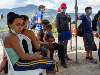 Detained Honduran migrants wait at a police checkpoint to be returned by buses to El Florido, one of the border points between Guatemala and Honduras, near Zacapa, Guatemala, Wednesday, Jan. 20, 2021. A once large caravan of Honduran migrants that pushed its way into Guatemala last week in hopes of …