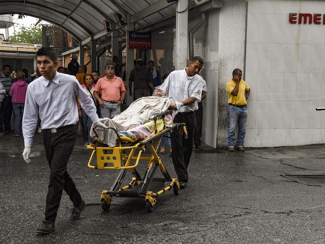 A patient of the University Hospital is transported in a stretcher outside the building in Barquisimeto, Venezuela on April 24, 2019. - Venezuela is facing the worst crisis in its modern history with inflation expecting to soar a mind-boggling 10 million percent this year, contributing to a shortage of basic …