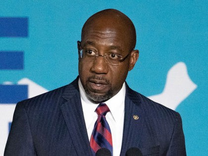 ATLANTA, GA - JUNE 18: Sen. Rev. Raphael Warnock (D-GA) speaks with community members and students at Clark Atlanta University during a vaccine event lead by Vice President Kamala Harris on June 18, 2021 in Atlanta, Georgia. Vice President Harris is visiting Atlanta as part of a nationwide tour to …