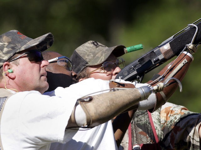 Delvin McMillian, 27, center, of Birmingham, Ala., gets help shooting at clay pigeons with volunteer shooting instructors Frank Dennis, left, and Chris Geiger, right, Friday Sept. 29, 2006 in Jackson's Gap, Ala. Twenty five disabled veterans were in rural east Alabama for Operation Adventure, an outdoor sports program put on …