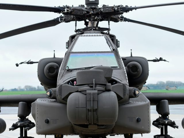 US AH-64 Apache helicopters is parked on the tarmac at Shape Airfield at Chievres Air Base in Belgium, on October 24, 2017. The 1st Cavalry Brigade made a refuelling stop at the base in Belgium on its way to a nine-month rotation in Illesheim, Germany to support Operation Atlantic Resolve …