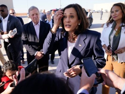 Vice President Kamala Harris talks to the media after stepping off Air Force Two, Friday,