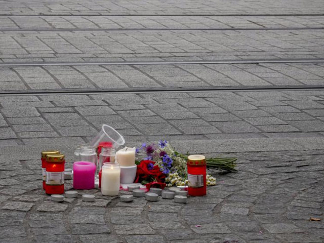 Flowers and candles were laid near the crime scene in central Wuerzburg, Germany, Saturday