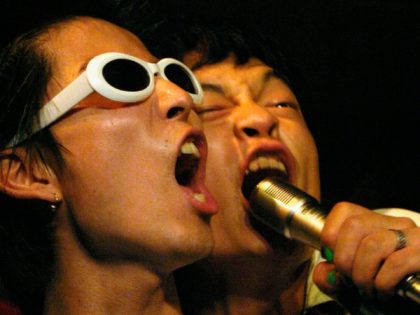 BEJING, CHINA - JULY 27: Local rappers perform in a nightclub on the outskirts of Beijing on July 27, 2003 in Beijing, China. Although China has joined the WTO (World Trade Organization), CD piracy is rampant and as a result young musicians refrain from engaging in professional musical careers. Rap …