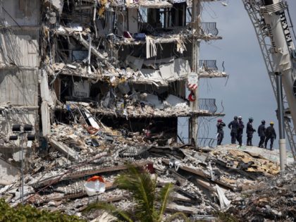 SURFSIDE, FLORIDA - JUNE 27: Search and Rescue teams look for possible survivors in the partially collapsed 12-story Champlain Towers South condo building on June 27, 2021 in Surfside, Florida. Over one hundred people are being reported as missing as the search-and-rescue effort continues. (Photo by Joe Raedle/Getty Images)