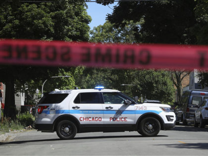 Police tape marks off a Chicago street as officers investigate the scene of a fatal shooting in the city's South Side on Tuesday, June 15, 2021. An argument in a house erupted into gunfire early Tuesday, police said. (AP Photo/Teresa Crawford)