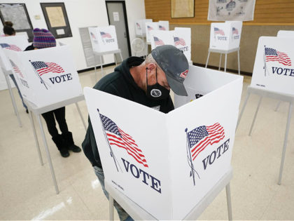 Chris Helps, of Earlham, Iowa, fills out his ballot during early voting, Tuesday, Oct. 20, 2020, in Adel, Iowa. (AP Photo/Charlie Neibergall)