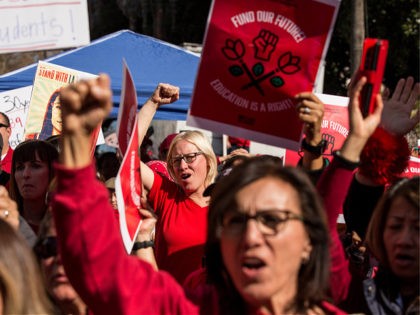 LOS ANGELES, CA - JANUARY 22: Educators, parents, students, and supporters of the Los Angeles teachers strike wave and cheer in Grand Park on January 22, 2019 in downtown Los Angeles, California.Thousands of striking teachers cheered for victory at the rally after it was announced that a tentative deal between …