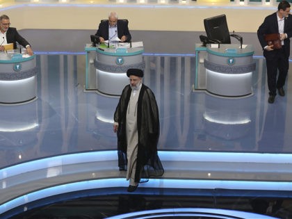In this picture made available by Young Journalists Club, YJC, leading presidential candidate for June 18, elections Ebrahim Raisi, center, leaves as other candidates Alireza Zakani, left, Mohsen Mehralizadeh, center at rear, and Amir Hossein Ghazizadeh Hashemi, are seen at the conclusion of their second TV debate in a state-run …