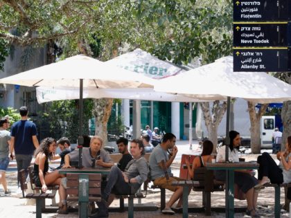 Israelis sit at a coffee shop in Tel Aviv on May 27, 2020 as restaurants were allowed to o