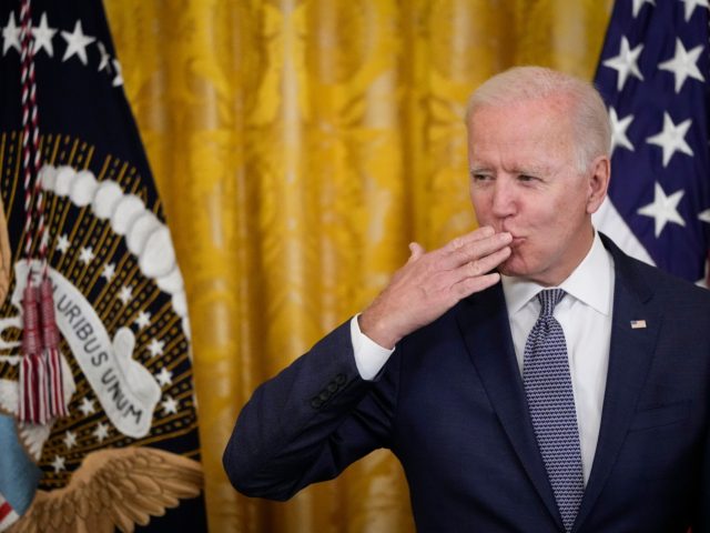 WASHINGTON, DC - JUNE 17: U.S. President Joe Biden blows a kiss to the audience before signing the Juneteenth National Independence Day Act into law in the East Room of the White House on June 17, 2021 in Washington, DC. The Juneteenth holiday marks the end of slavery in the …
