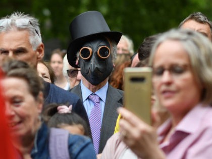 TOPSHOT - People gather to listen to speakers at a protest organised by "Keep Britain Free" in London on July 19, 2020, in response to the government's decision to impose mask wearing for shoppers as a precaution against the transmission of the novel coronavirus. - The protesters are reacting against …