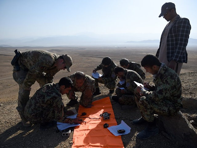 In this photograph taken on October 18, 2016, NATO-led US army Joint Terminal Attack Controller Tech (JTAC) and Afghan army tactical air controllers review coordinate points during an airstrike training mission on the outskirts of Logar province. Under pressure from the Taliban, Afghanistan's military is increasingly relying on the country's …