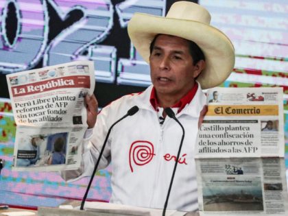Peruvian presidential candidate, socialist Pedro Castillo, shows newspaper headlines during the last debate with his opponent, right-wing candidate Keiko Fujimori, ahead of the June 6 run-off election, in Arequipa, Peru, on May 30, 2021. (Photo by SEBASTIAN CASTANEDA / X07403 / AFP) (Photo by SEBASTIAN CASTANEDA/X07403/AFP via Getty Images)