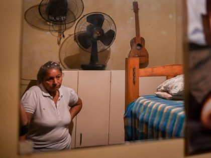 The mother of Geovanny Lopez, who disappeared in a shipwreck en route from Venezuela to Trinidad and Tobago on May 16, 2019, is seen at her son's bedroom during an interview with AFP at her house in Cota 905 neighbourhood in Caracas, on February 26, 2020. - Criminal groups that …