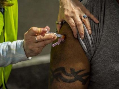 A patient with a traditional Fijian tattoo receives a COVID-19 vaccination on February 4,