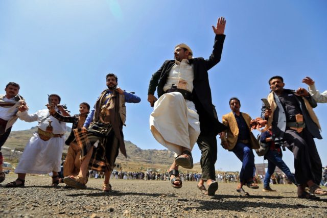 Yemeni fighters loyal to the Iran-backed Huthi rebels perform a traditional dance during a