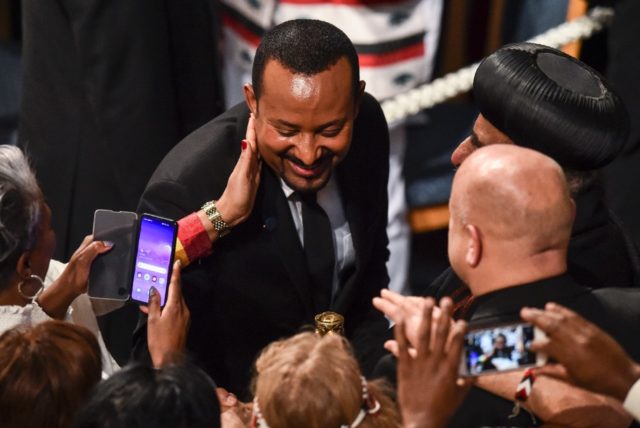 Ethiopia's Prime Minister Abiy Ahmed Ali is greeted by well wishers after receiving the No