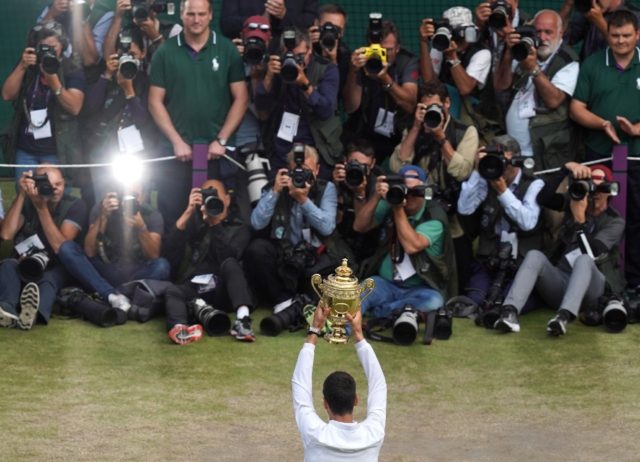 Centre of attention: Novak Djokovic holds the winner's trophy after beating Roger Federer