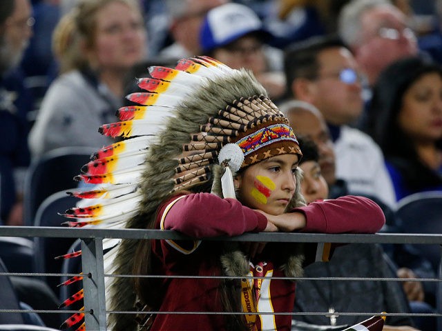 A fan watches an NFL football game between the Dallas Cowboys and the Washington Redskins in Arlington, Texas, Sunday, Dec. 15, 2019. (AP Photo/Michael Ainsworth)