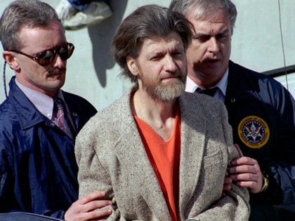 FILE - In this April 4, 1996 file photo, Ted Kaczynski, better known as the Unabomber, is flanked by federal agents as he is led to a car from the federal courthouse in Helena, Mont. Twenty years after the arrest of Kaczynski, some Lincoln residents remember him as an odd …