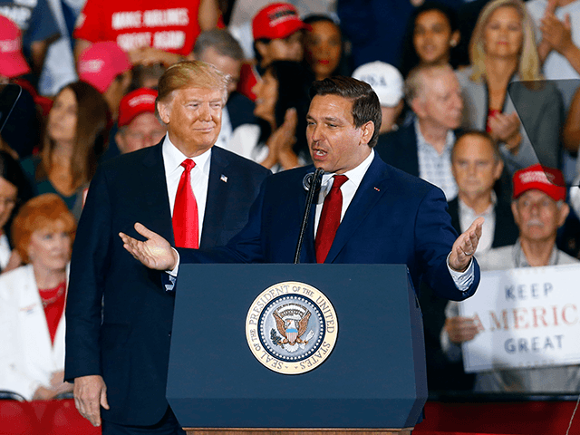 President Donald Trump stands behind Ron DeSantis, Candidate for Governor of Florida, as he speaks at a rally, Saturday, Nov. 3, 2018, in Pensacola, Fla. (AP Photo/Butch Dill)