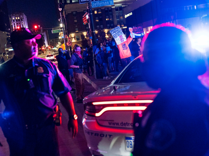 Police separate a group of Trump supporters demonstrating against the election results from counter protestors, seen in the background, outside the central counting board at the tcf Center in Detroit, Thursday, Nov. 5, 2020. (AP Photo/David Goldman)