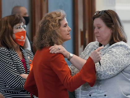 Texas State Rep. Donna Howard, D-Austin, center, visits with Rep. Julie Johnson, D-Dallas, right, in the House Chamber, Wednesday, May 5, 2021, in Austin, Texas. Howard and Johnson oppose a bill introduced in Texas that would ban abortions as early as six weeks and allow private citizens to enforce it …