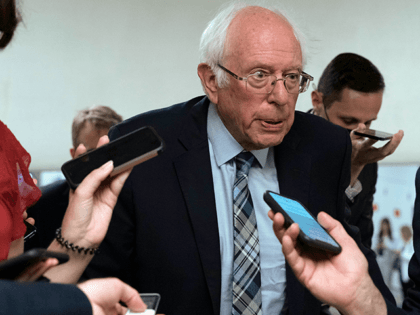 Sen. Bernie Sanders (I-VT), talks to reporters as he walks to the Senate chamber ahead of a test vote scheduled by Democratic Leader Chuck Schumer (NY) on the infrastructure deal senators brokered with President Joe Biden at the time, on Capitol Hill, in Washington, DC, July 21, 2021. (AP Photo/Jose …