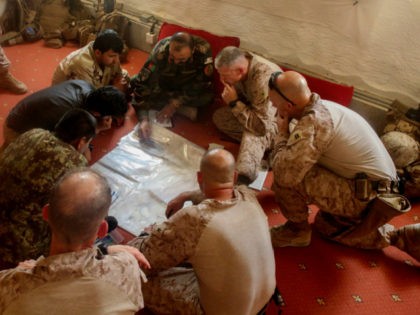 This June 13, 2017 photo released by Operation Resolute Support headquarters shows U.S. Marines with Task Force Southwest and Afghan National Army soldiers with the 215th Corps planning for the continuation of offensive combat operations at Camp Hanson, Afghanistan. Sixteen years into its longest war, the United States is sending …