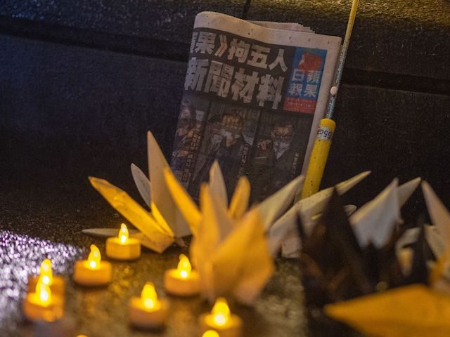 A copy of Hong Kong's pro-democracy Apple Daily newspaper is seen during a vigil following