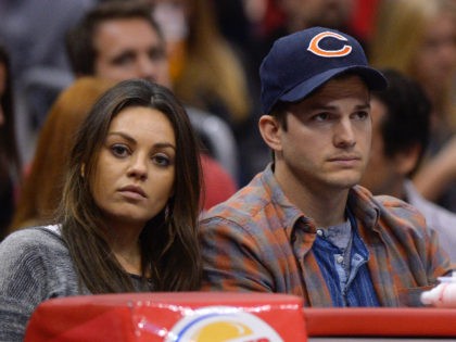 Actors Mila Kunis, left, and Ashton Kutcher watch the Los Angeles Clippers play the Detroit Pistons during the second half of an NBA basketball game, Saturday, March 22, 2014, in Los Angeles. (AP Photo/Mark J. Terrill)