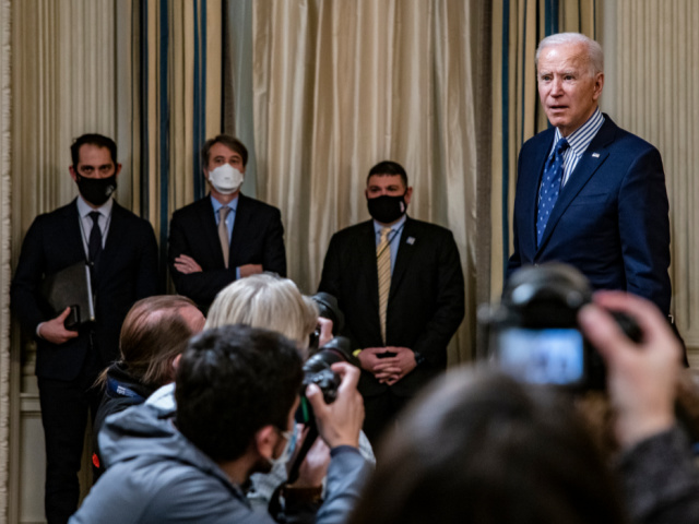 President Joe Biden stops to answer questions from reporters after speaking in the State Dining Room with Vice President Kamala Harris behind him following the passage of the American Rescue Plan in the U.S. Senate at the White House on March 6, 2021 in Washington, DC. The Senate passed the latest COVID-19 relief bill by 50 to 49 on a party-line vote, after an all-night session. (Photo by Samuel Corum/Getty Images)