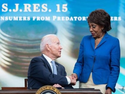 US President Joe Biden sits alongside Speaker of the House Nancy Pelosi (L), Representative Chuy Garcia (R), (D-IL), and Representative Maxine Waters (2nd R), (D-CA), prior to signing S.J. Res. 15, a bill dealing with predatory lending practices, into law during a ceremony in the Eisenhower Executive Office Building in …