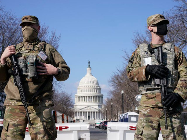 In this file photo, National Guard troops keep watch on the Capitol, Thursday, March 4, 2021, on Capitol Hill in Washington. (AP Photo/Jacquelyn Martin