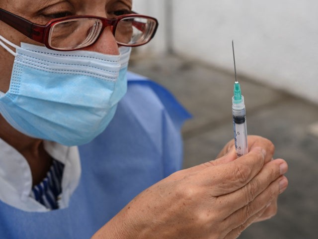 health worker prepares a dose of the CoronaVac vaccine, developed by China's Sinovac firm,