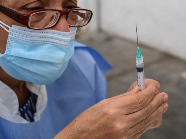 health worker prepares a dose of the CoronaVac vaccine, developed by China's Sinovac firm, during a vaccination day against COVID-19 for clinical and medical personnel from the private sector in Caracas on May 28, 2021. (Photo by Yuri CORTEZ / AFP) (Photo by YURI CORTEZ/AFP via Getty Images)
