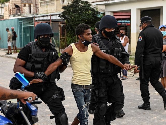 A man is arrested during a demonstration against the government of President Miguel Diaz-Canel in Arroyo Naranjo Municipality, Havana on July 12, 2021. - Cuba on Monday blamed a "policy of economic suffocation" of United States for unprecedented anti-government protests, as President Joe Biden backed calls to end "decades of …