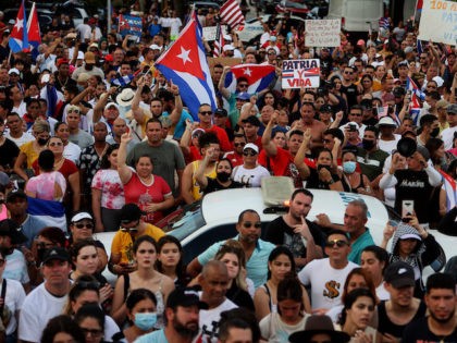 MIAMI, FLORIDA - JULY 11: Protesters gather in front of the Versailles restaurant to show support for the people in Cuba who have taken to the streets there to protest on July 11, 2021 in Miami, Florida. Thousands of Cubans took to the streets across the country to protest pandemic …