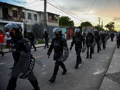 TOPSHOT - Riot police walk the streets after a demonstration against the government of President Miguel Diaz-Canel in Arroyo Naranjo Municipality, Havana on July 12, 2021. - Cuba on Monday blamed a "policy of economic suffocation" of United States for unprecedented anti-government protests, as President Joe Biden backed calls to …