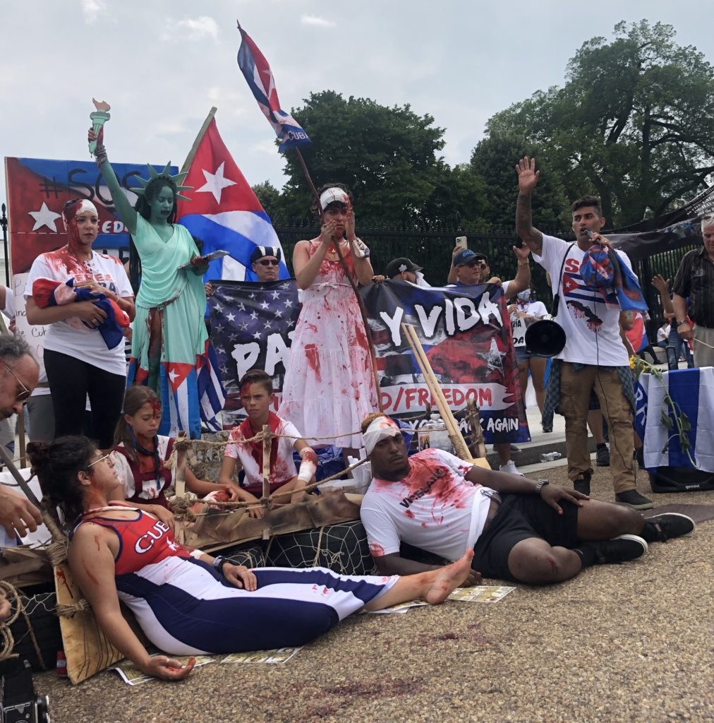 The art display in front of the White House Sunday featured Lady Liberty with her lips sewn symbolically shut, and protesters, including children, marred with fake blood. (Madeleine Hubbard/Breitbart News)