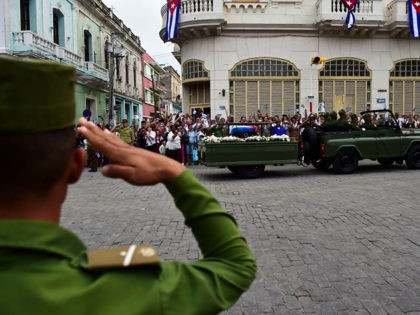 The urn with the ashes of Cuban leader Fidel Castro is driven through Santa Clara, Cuba, on December 1, 2016 during its four-day journey across the island for the burial in Santiago de Cuba. - A military jeep is taking the ashes of Fidel Castro on a four-day journey across …