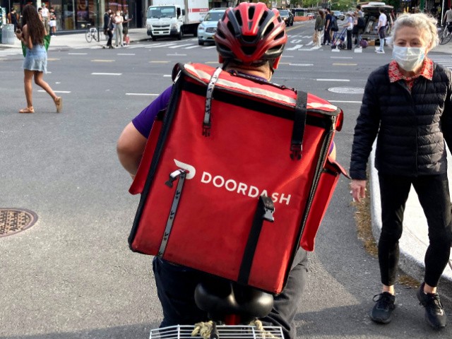 DoorDash allows restaurants to choose commissions in a post-pandemic world.  Here, a DoorDash delivery man is shown in Manhattan.