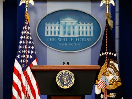 WASHINGTON, DC - AUGUST 18: The American flag sits next to a empty speaker podium before U.S. President Barack Obama gives a statement during a press conference in the Brady Press Briefing Room of the White House on August 18, 2014 in Washington, DC. Obama returned early from his vacation …