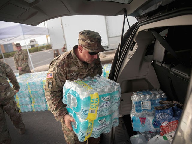 PANAMA CITY, FL - OCTOBER 15: Soldiers from the Florida Army National Guard pass out water