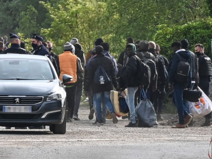 Police supervise the evacuation of a migrant camp on the road to Saint-Omer near Calais, northern France, on June 4, 2021. - A large police force was mobilized to proceed with the evacuation of around 600 migrants who had occupied for a few months the so-called 'Magnesia' fallow land near …