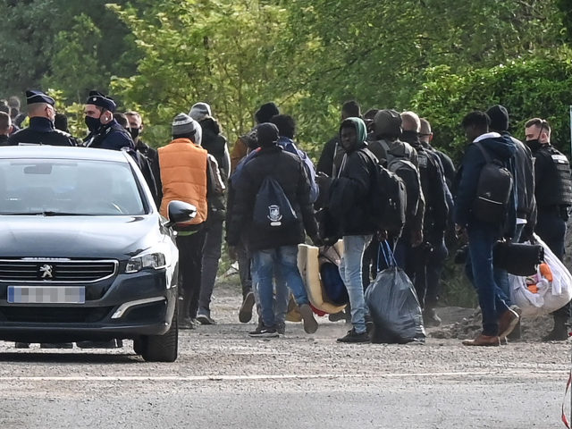 Police supervise the evacuation of a migrant camp on the road to Saint-Omer near Calais, n