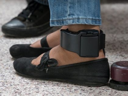 TOPSHOT - An ankle monitor is seen on a migrant woman from El Salvador, recently released from federal detention with fellow Central American asylum seekers, at a bus depot on June 12, 2019, in McAllen, Texas. (Photo by Loren ELLIOTT / AFP) (Photo credit should read LOREN ELLIOTT/AFP via Getty …